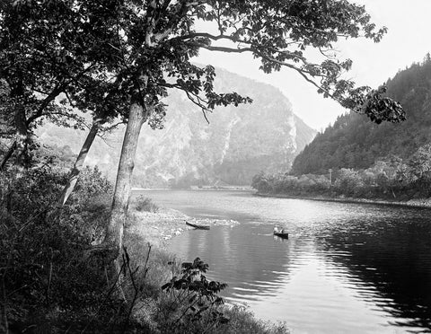 A vintage, black and white photograph of a canoe on the Delaware Water Gap