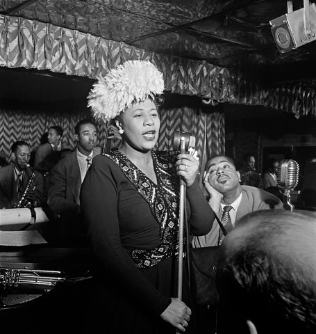 A vintage photograph of Billie Holiday performing live