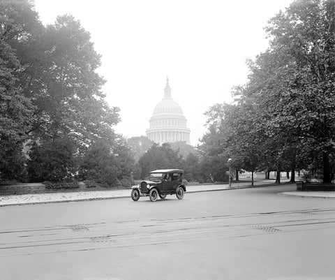 A vintage image of a Ford touring car in Washington DC, with the Capitol Building in the background