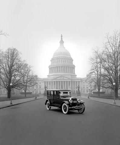 A vintage Ford vehicle parked in front of the US Capitol in Washington DC