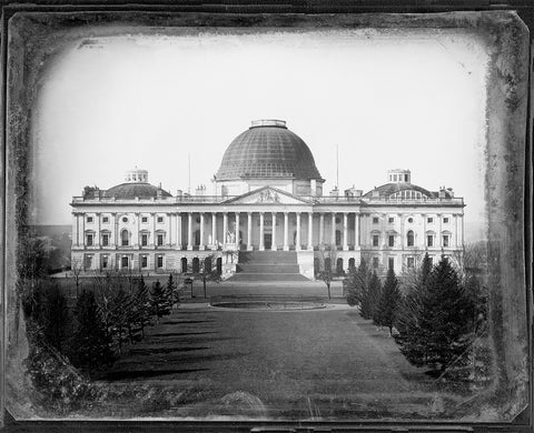 A vintage photograph of the Capitol Building with the old wooden dome