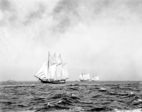 A black and white photograph of three ships sailing on the ocean
