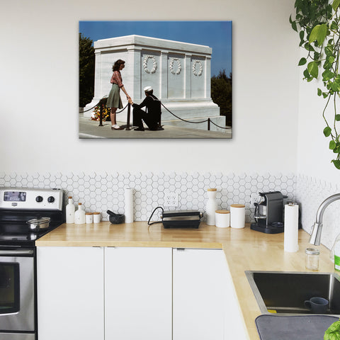 A mockup of a canvas print of a vintage photograph hanging in a kitchen