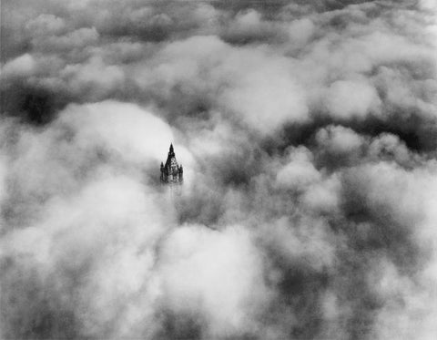 The top of Woolworth Tower above dense clouds
