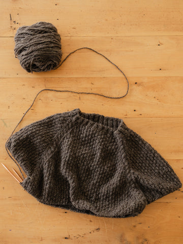 flat lay grey textured sweater in progress using handspun yarn