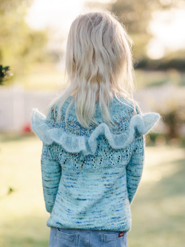 view from behind of effervescent mini sweater including the optional ruffle