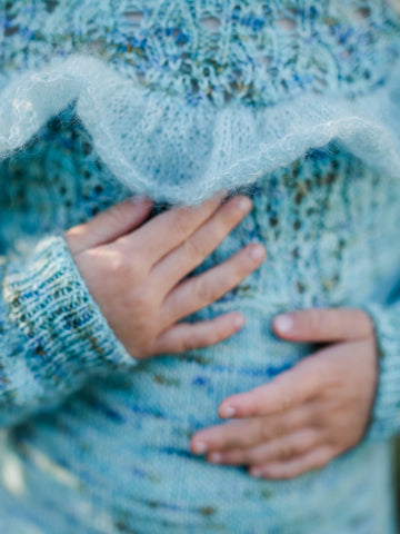 girls hands feel detail on hand knit sweater