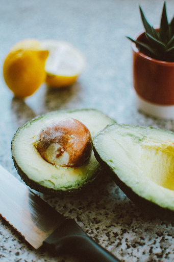 picture of avocado sliced open on a surface