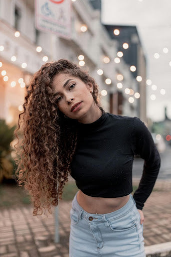 Woman with hair extensions in her curly hair.