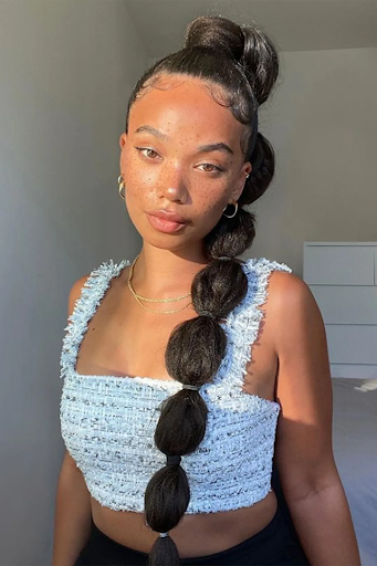 Image of bubble braid style on a woman with dark long hair