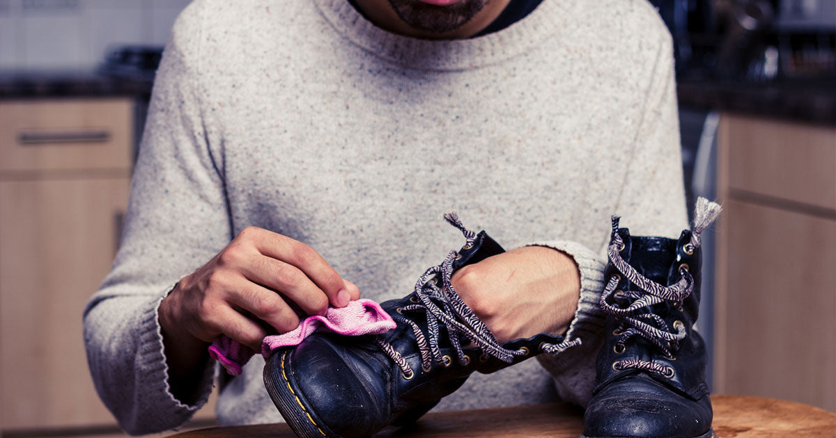 Man polishing his black boots