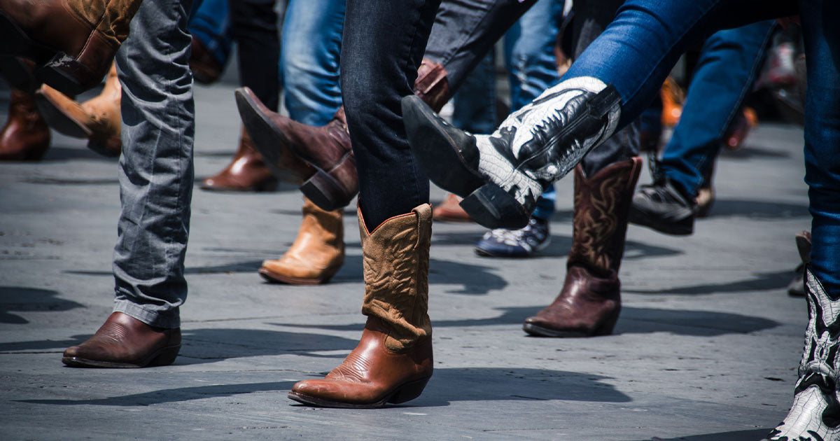 People line dancing in cowboy boots