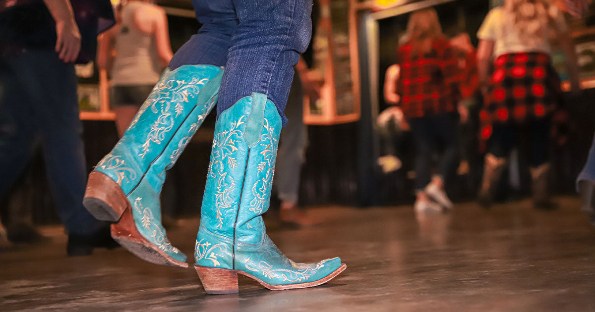 Woman wearing teal cowboy boots