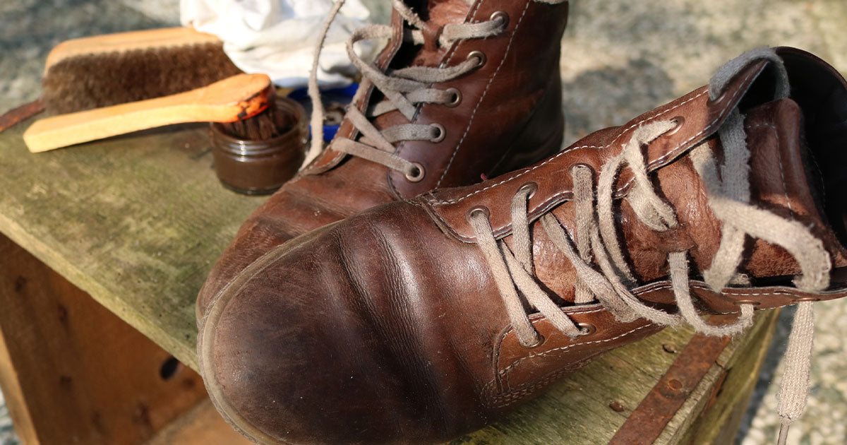 Worn leather boots on table