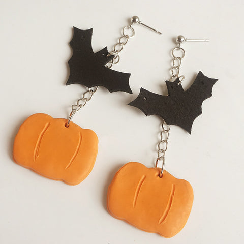 Earring featuring a dangling pumpkin and bat charm, perfect for Halloween