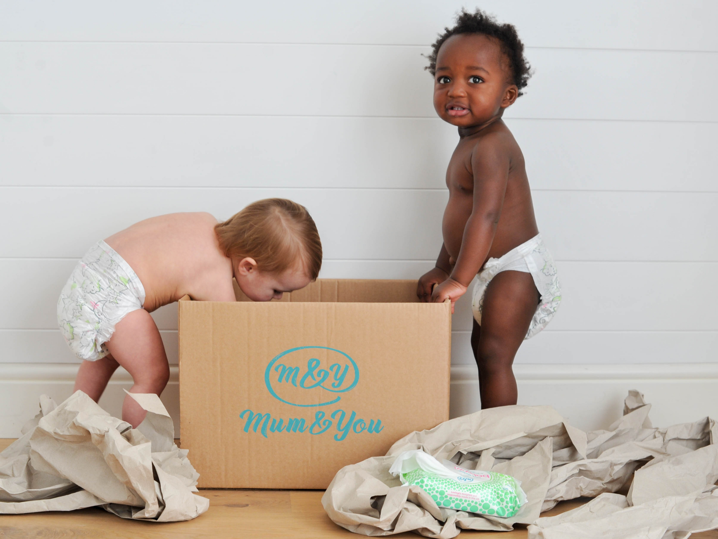 Baby's looking at cardboard box 