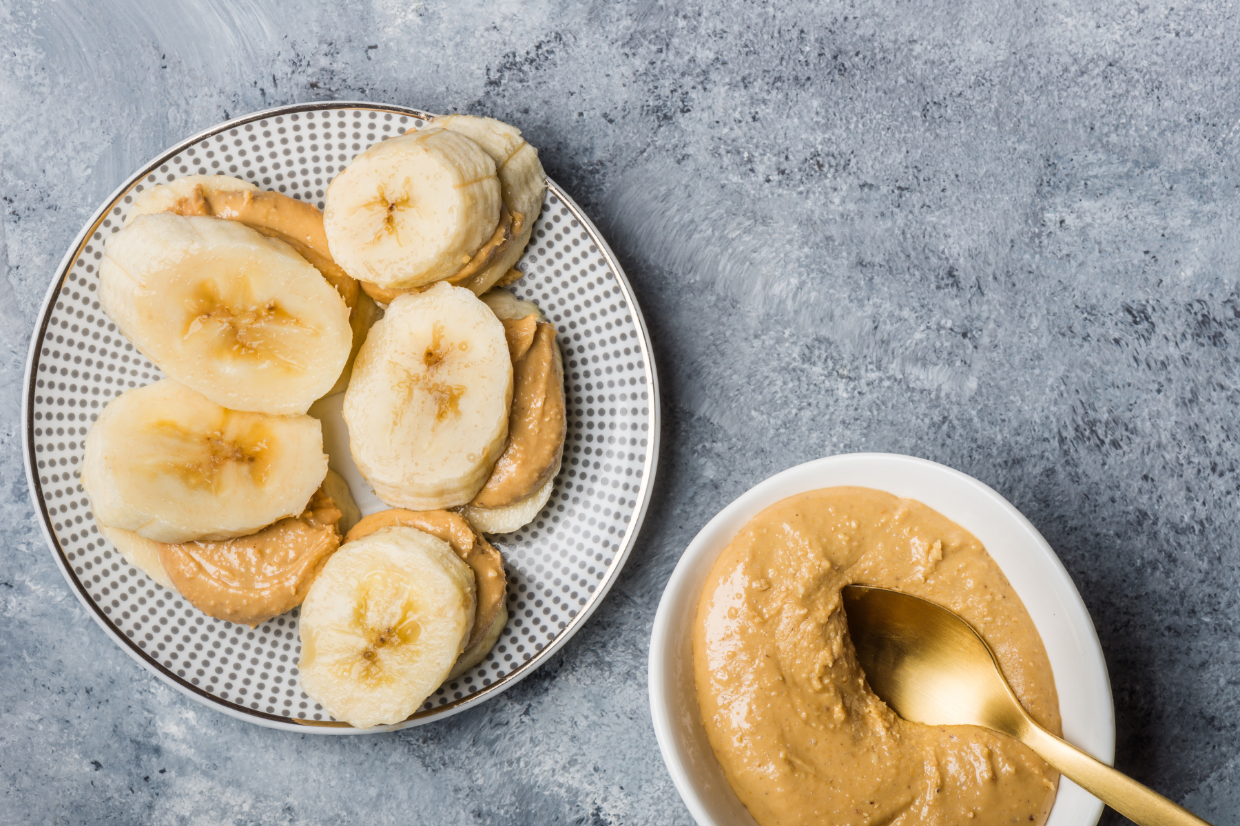 Plate with banana peanut butter spread, a delicious and nutritious snack.