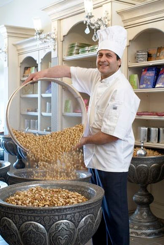 Chef Ayoub of Ayoub's Dried Fruits and Nuts, pouring steaming freshly roasted nuts in our store.