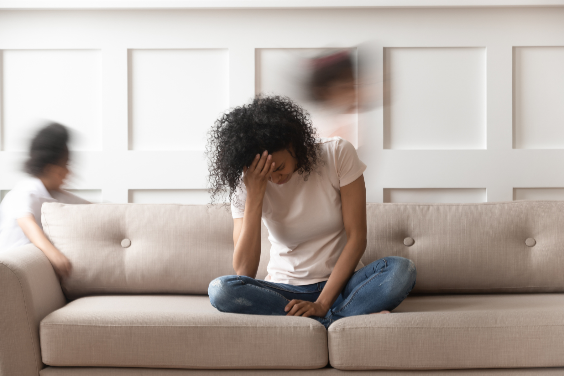 Women with her head in her hands, experiencing extreme fatigue in perimenopause.