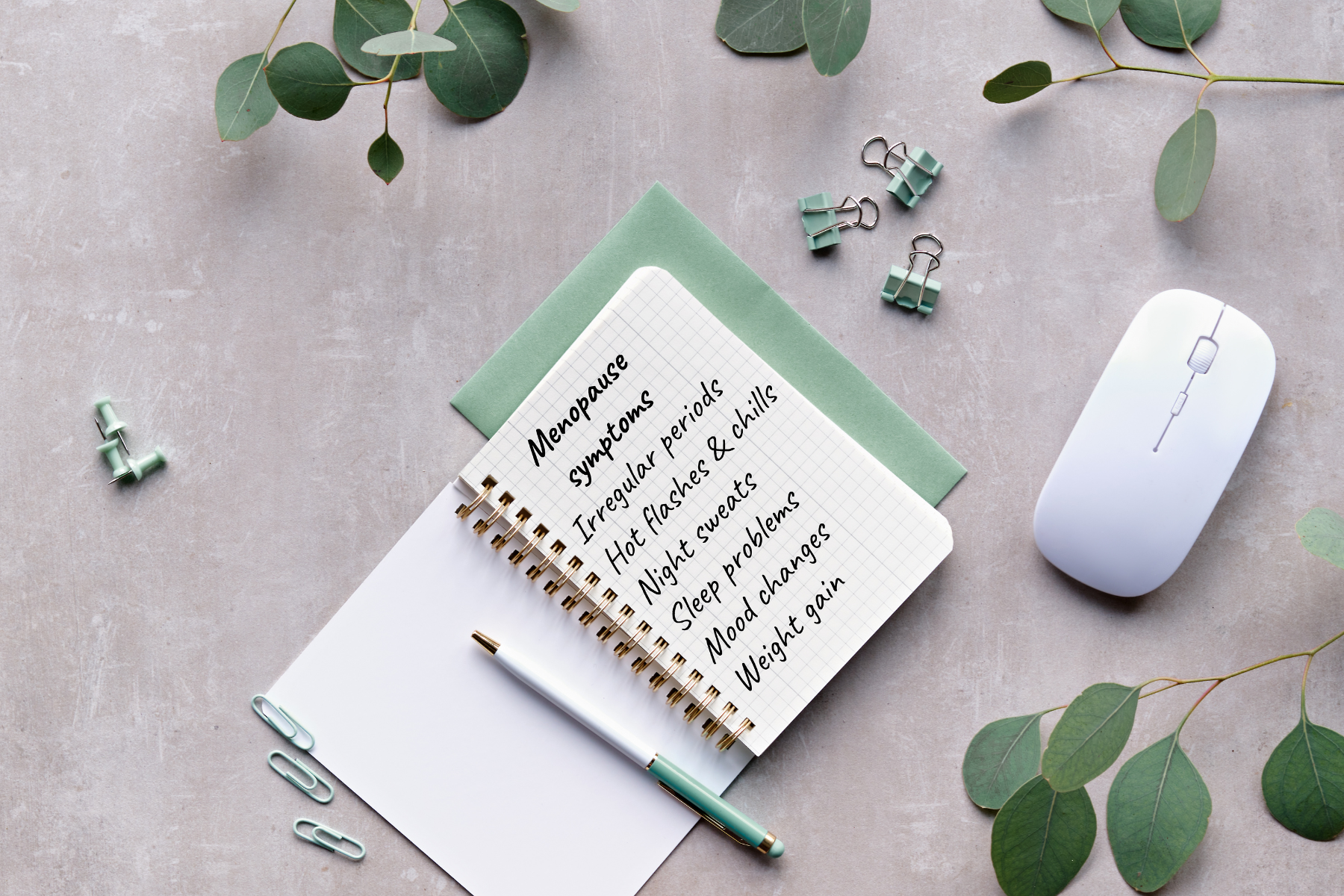 A notepad laid neatly on a desk with a page open of a list of menopause symptoms.