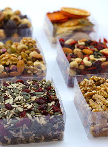 clear boxes of our trail mixes, of dried fruits, nuts and seeds.