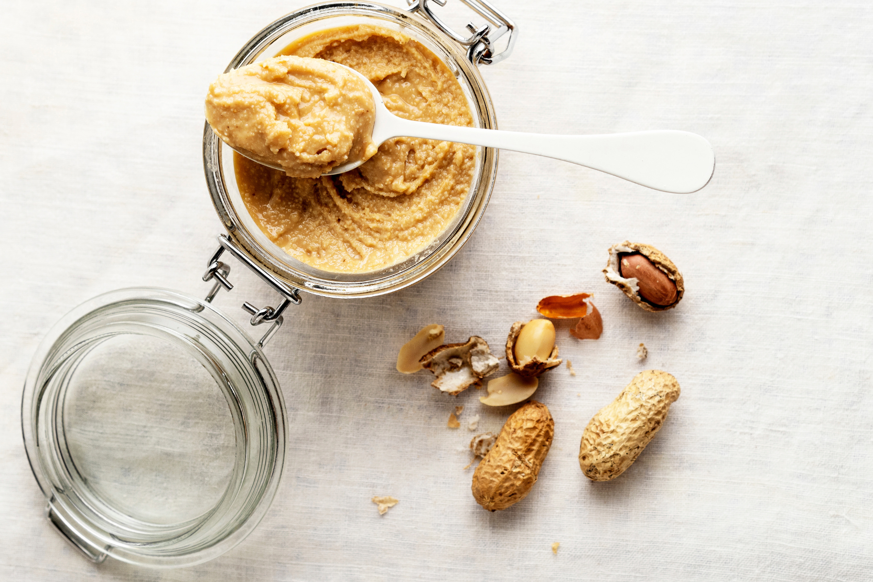 A jar filled with peanut butter and nuts, a healthy combination of flavors and nutrients.