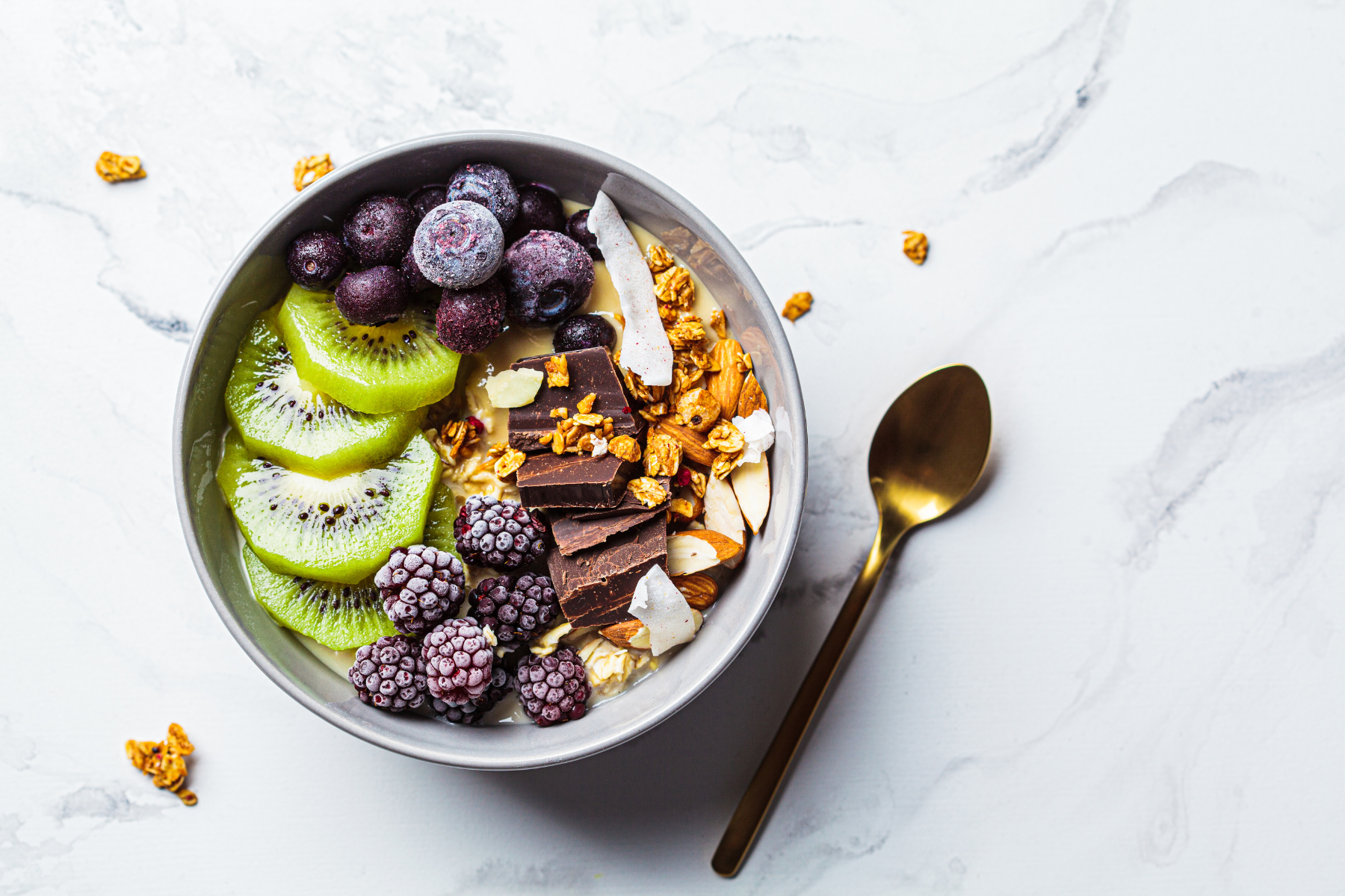 A nutritious breakfast bowl with chocolate, berries, nuts and peanut butter for added health benefits.