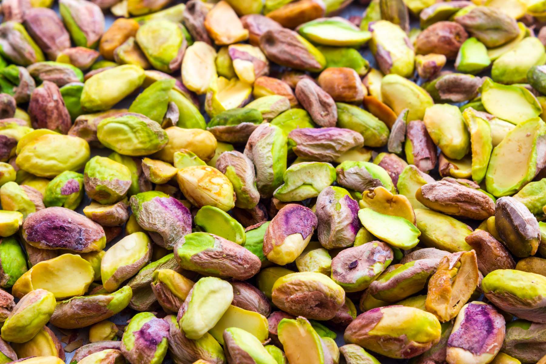 A close-up view of shelled pistachios ready for use in a pistachio nut butter recipe.