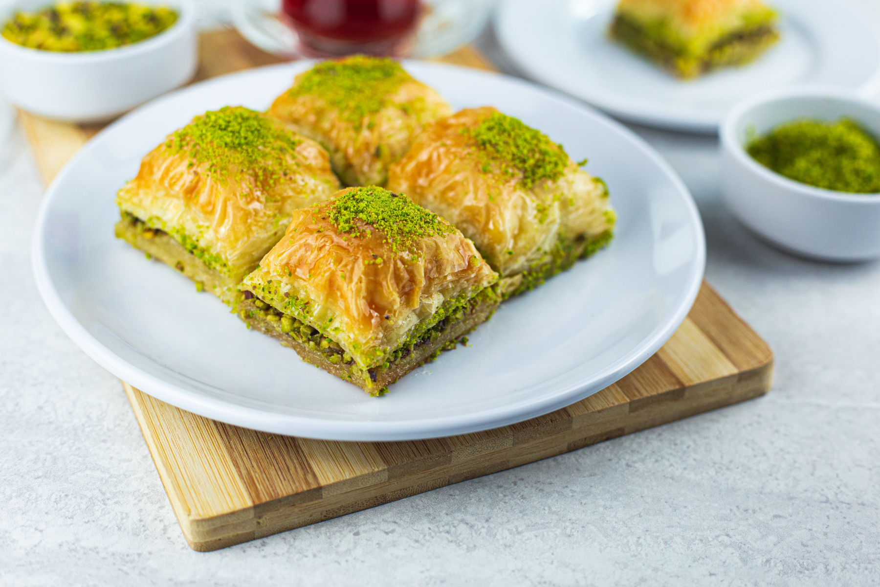 A plate of pistachio paste infused baklava, a sweet pastry dessert.