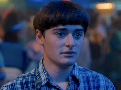 Photo of young teenage white boy with 70s bowl hair cut in plaid shirt.