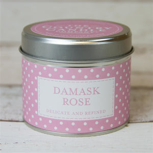 silver round tin with pink and white polka dot band labelled DAMASK ROSE with pink sticker on lid with writing The Country Candle Candle Company
