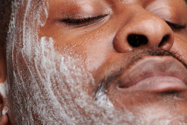 black man cleansing face to prevent ingrown hair boil