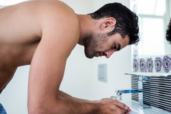 handsome man at sink washing face, urth