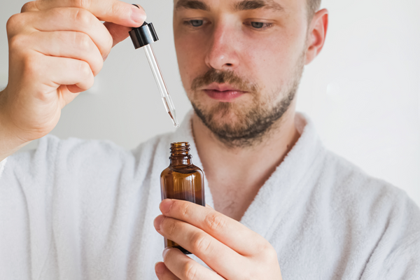 man with a dropper bottle serum with argireline, urth