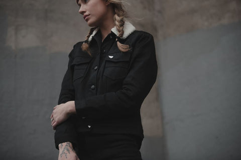 girl wearing a black denim motorcycle jacket