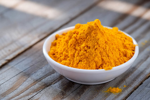 turmeric root in it's bright yellow powdered form