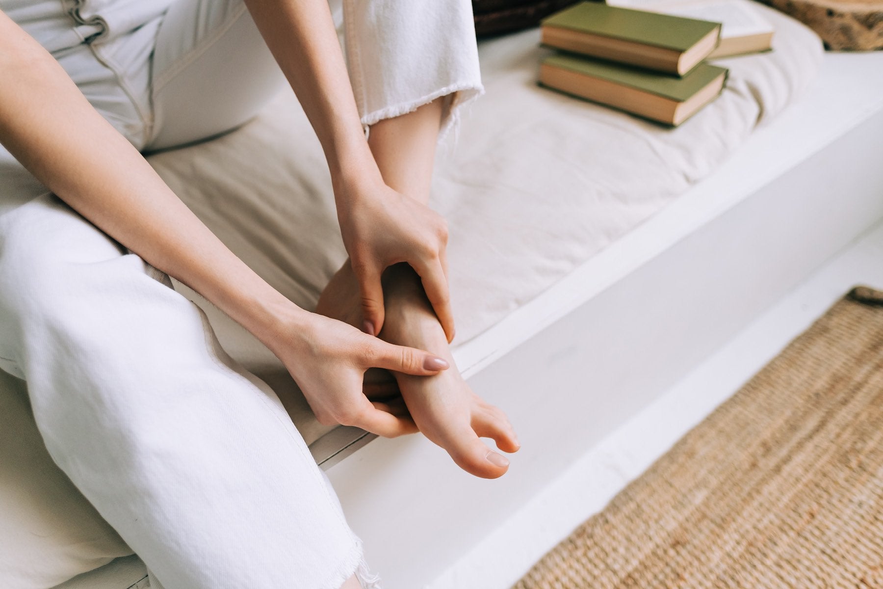 Woman giving herself a foot massage