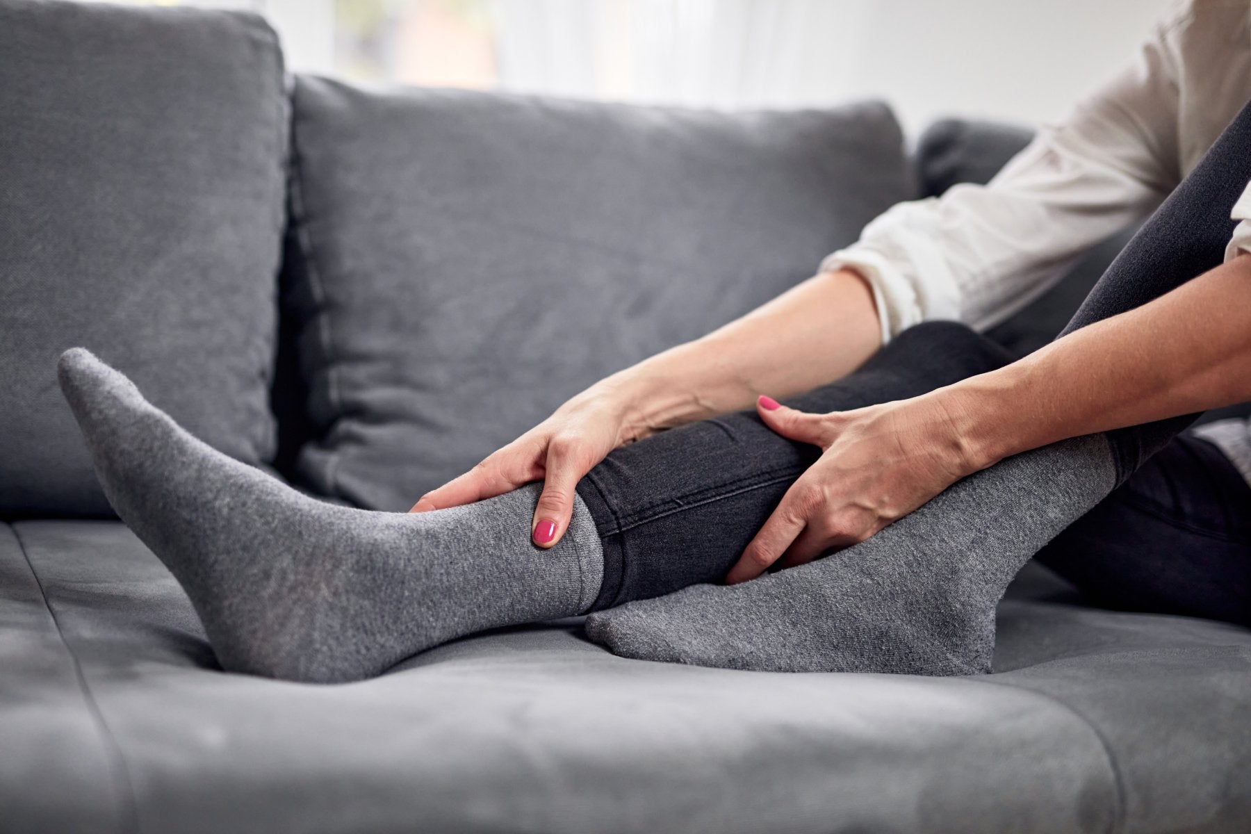 Woman massaging a muscle spasm on her calf