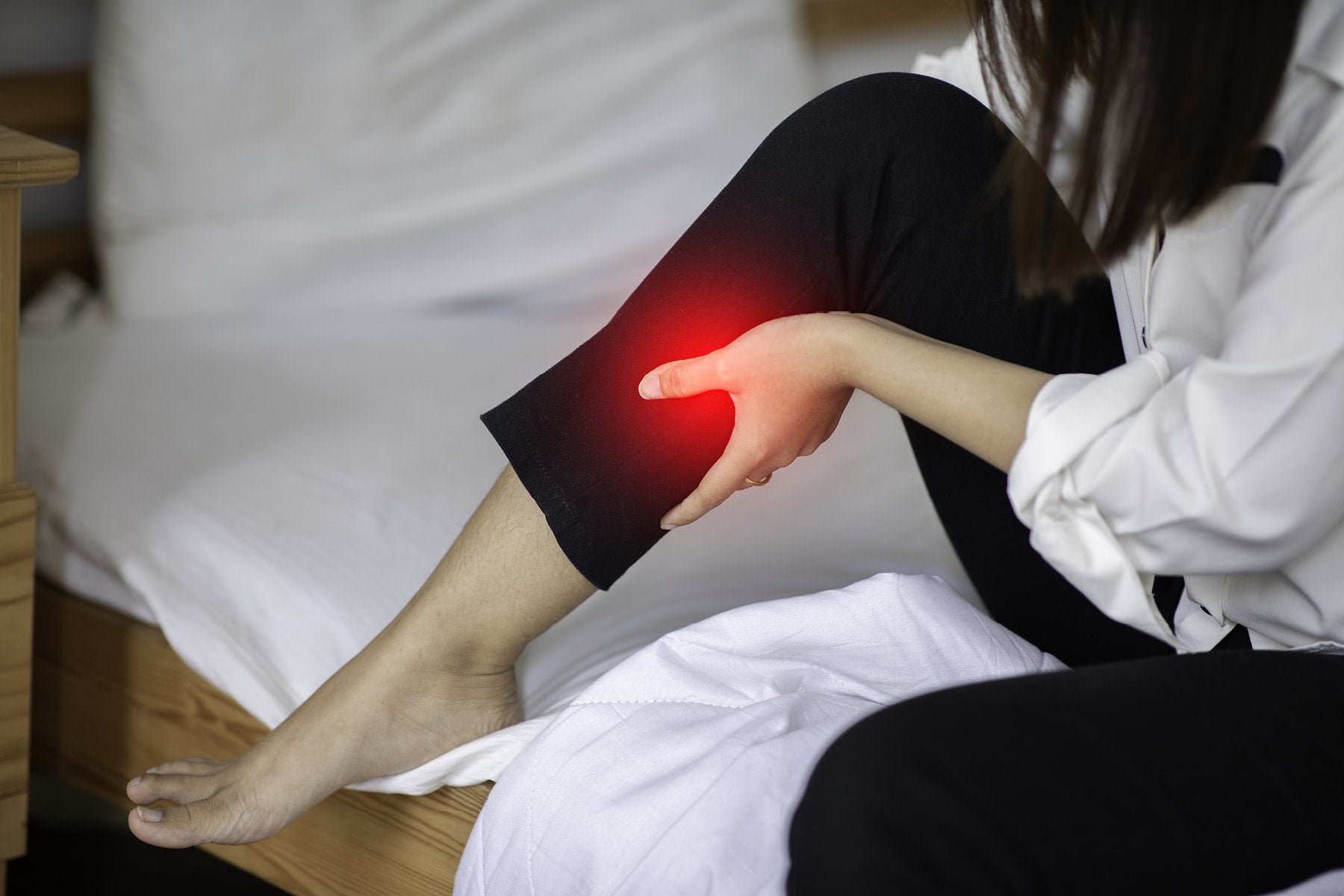 Woman pressing on sore muscles to feel good