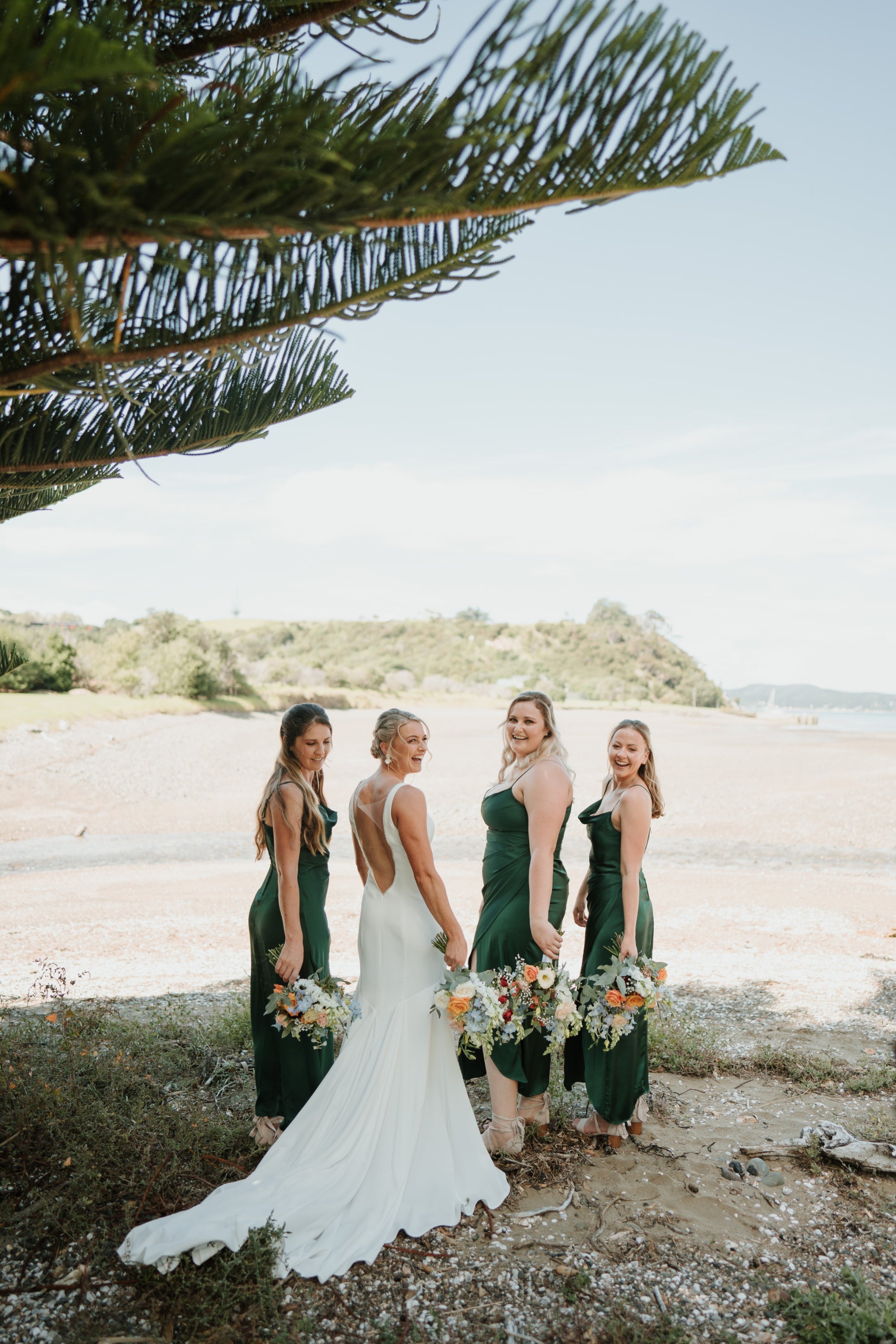 Mandy and bridesmaid green dresses | Tawharanui Beach | The Paper Gazelle