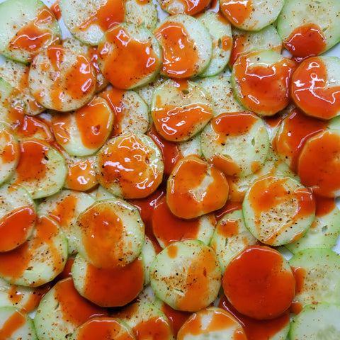 Spicy cucumber snack with hot sauce, lime, and tajin