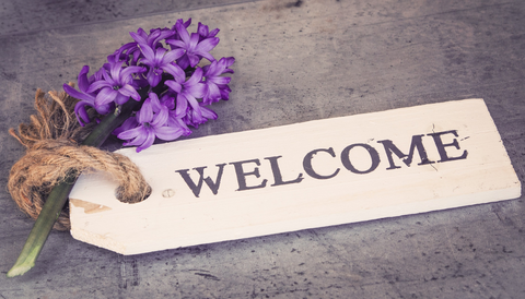 Image says 'Welcome' with a purple flower