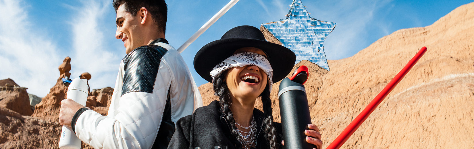 Two people holding Owala Star Wars water bottles