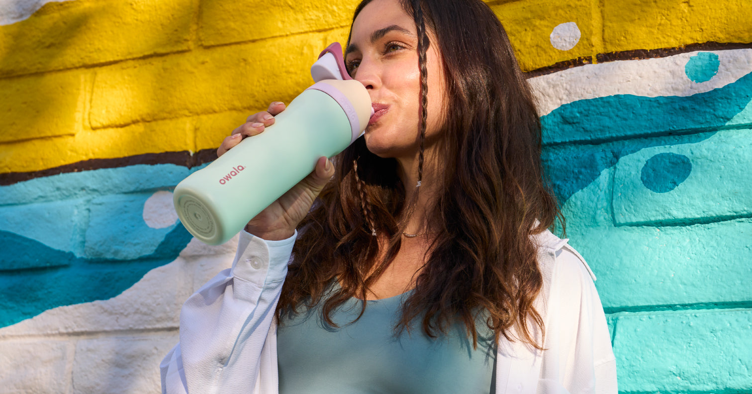 girl drinking a mint colored water bottle