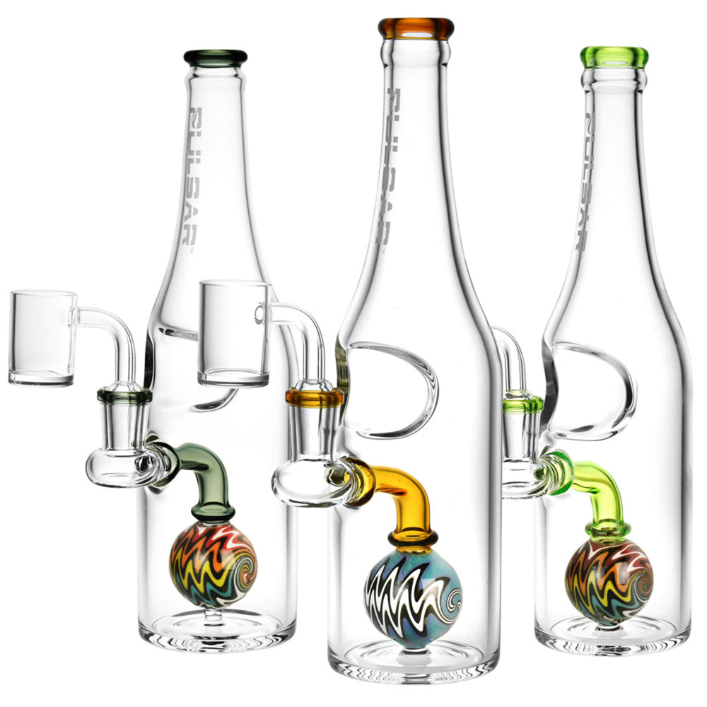 Pulsar Bottle Style Dab Rig 9.5". Pulsar Bottle Style Dab Rigs, on the left is a blue option. In the middle is an amber option. On the right is a green option.
