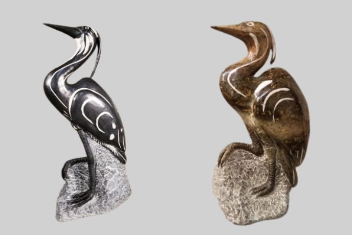 Shephard Deve's stone sculptures, "Black Heron" (left) and "Brown Heron" (right), made from serpentine stone with white dolomite inlay