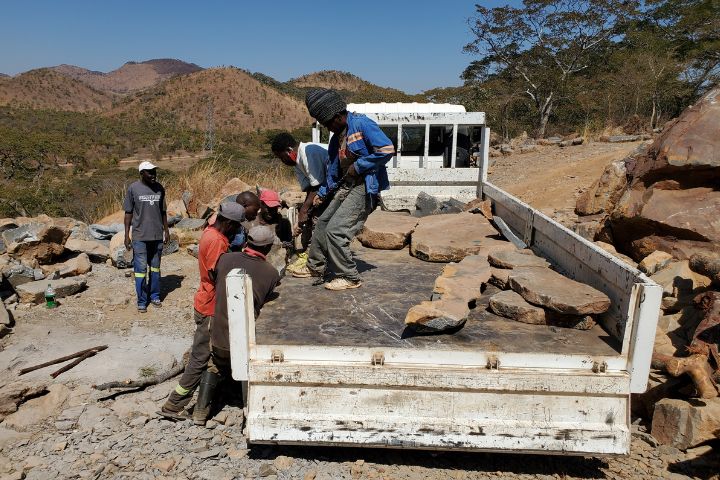 Truck carrying springstone boulders mined and loaded by Zimbabwean miners
