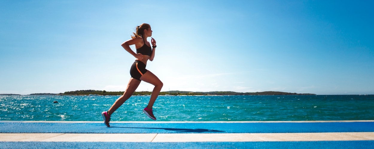 femme sportive court bord de mer