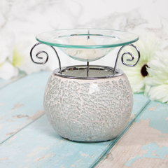 An image of an elegant oil warmer wax melt burner with crackled pearl glass design that brings a soothing atmosphere when releasing your favorite scent. Made from glass and ceramic material, perfect for any room and as a special gift or housewarming present. #oilwarmer #waxmeltburner #crackledpearlglass #scented #housewarminggift