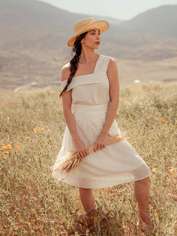 woman wearing white tencel top and sustainable midi banana skirt